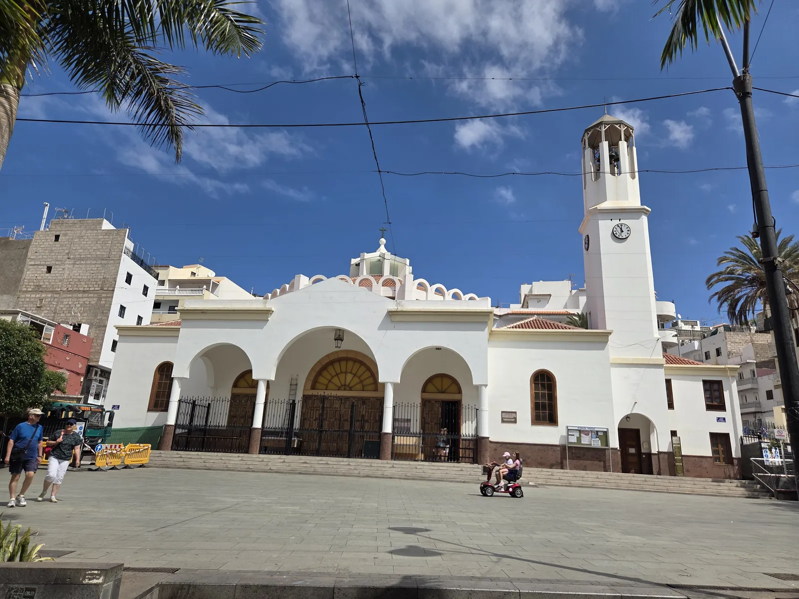 White arched façade and clock tower of Nuestra Señora del Carmen church in Los Cristianos