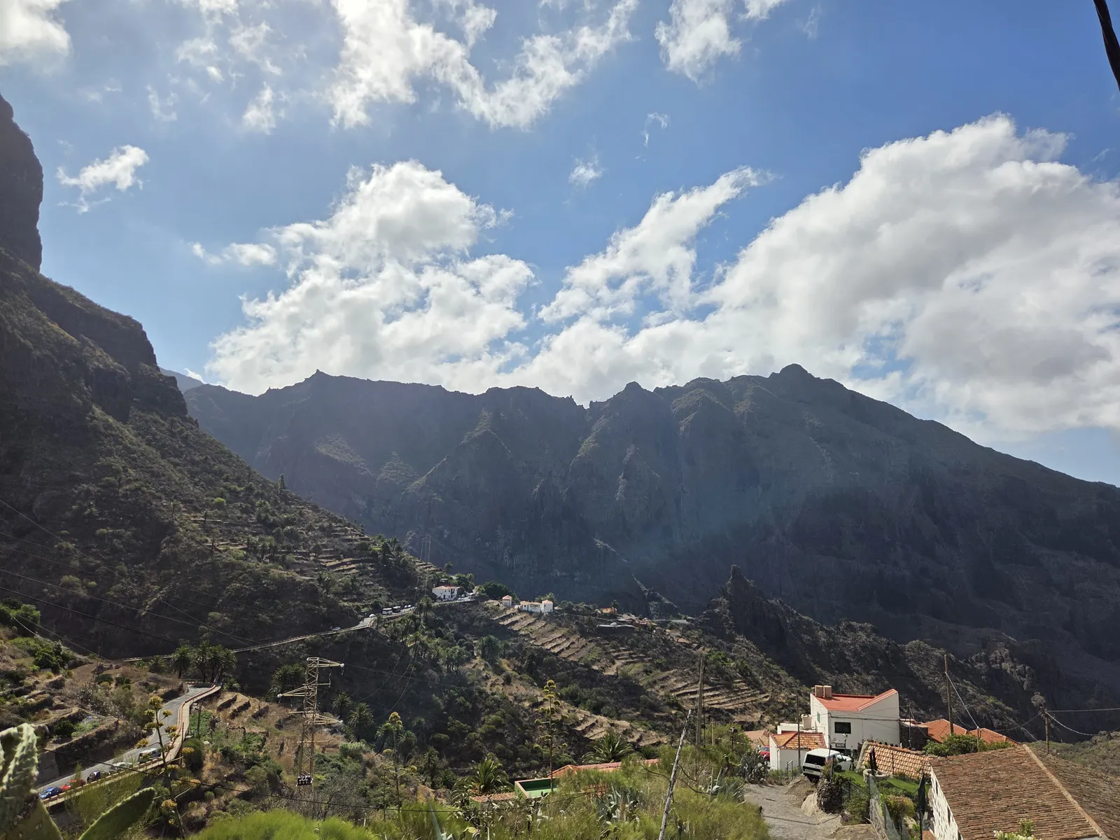 Masca’s terraced hillsides and scattered tiled-roof houses beneath a rugged mountain ridge