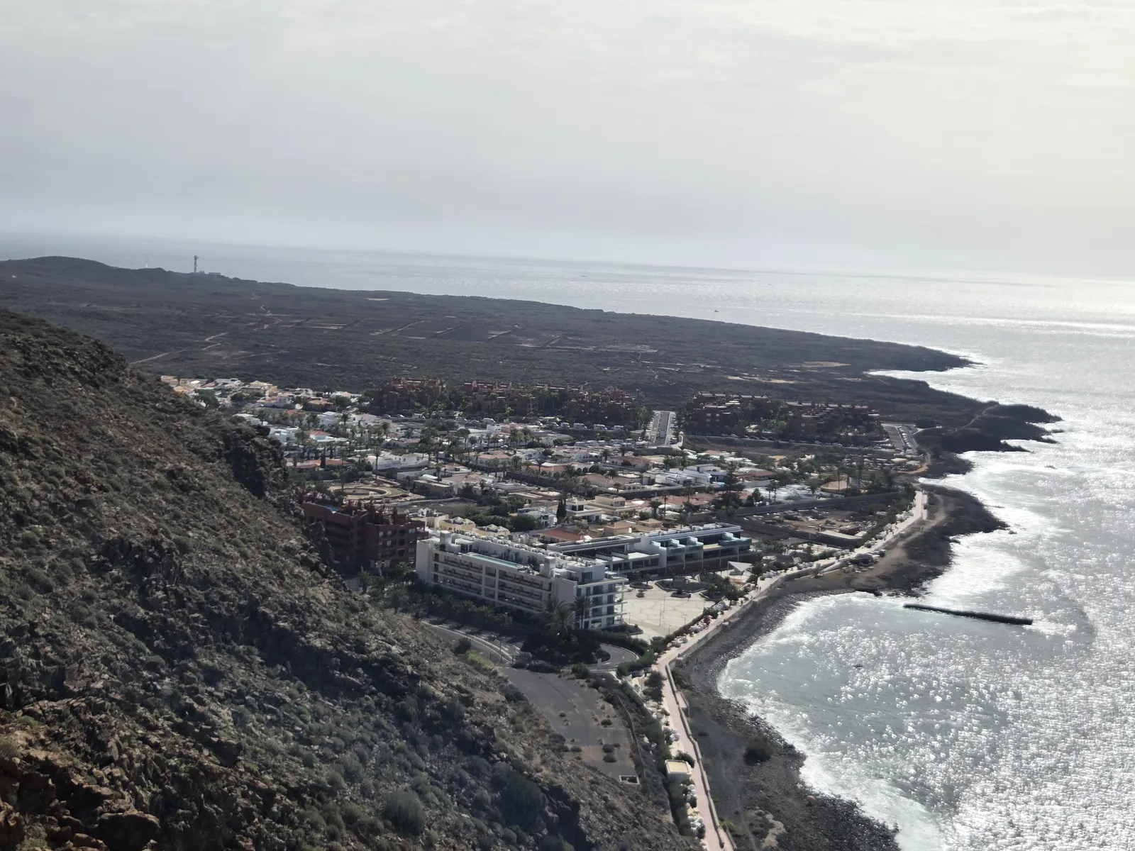 Elevated view of Palm-Mar, its waterfront and the volcanic coastline stretching towards Rasca