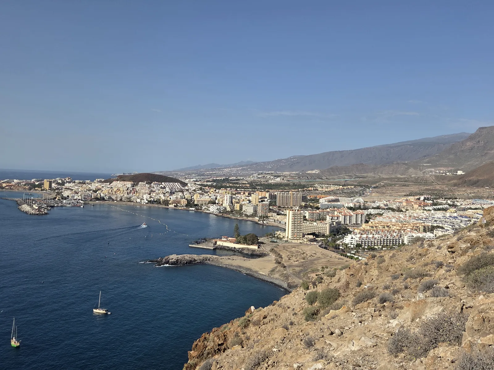 Los Cristianos Bay and waterfront buildings seen from the rocky slopes of Guaza